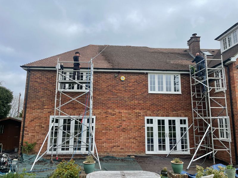 Roof cleaning carried out safely from scaffold towers by The Roof Moss Cleaners in St Neots